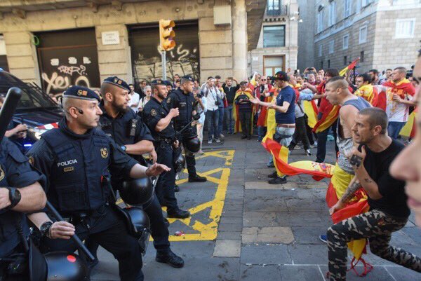 A protester with a swastika tattooed on his hand insulting Catalan police officers during unionist rally in Barcelona on Sunday (by @lagarder81)
